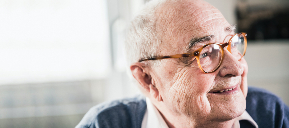 Photo of elderly white male smiling, looking off to the side
